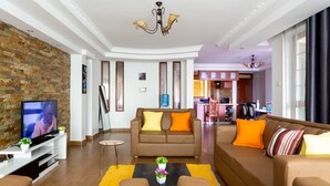 A modern living room with a television, sofa, and coffee table.