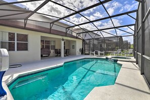 A covered outdoor swimming pool with a clear view of the sky and adjacent buildings. - Spacious Davenport Home w/ Private Pool & Spa (Davenport)