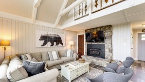 A living room with a sofa, armchair, coffee table, fireplace, and artwork. - 1 Mi to Beech Mtn Ski Resort: Home w/ Large Yard (Banner Elk)