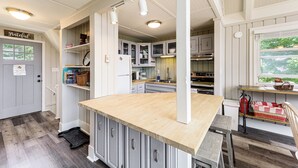 A kitchen with white cabinets, a wooden countertop, and a view of the outdoors through a window. - 1 Mi to Beech Mtn Ski Resort: Home w/ Large Yard (Banner Elk)