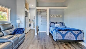 A bedroom with a bed, a sofa, a desk, and a walk-in closet. - Naples Studio w/ Resort Amenities - Near Marina! (Naples)