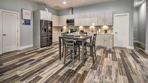 A modern kitchen with a central island, stainless steel appliances, and a herringbone-patterned floor. - Luxe, Modern Houston Apt - 1 Mile to The Galleria! (Houston)