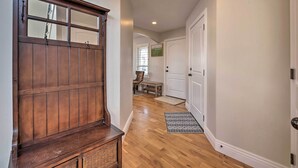 A hallway with wooden flooring, a bench, a door, and a window with blinds. - Mountain-view Home < 15 Mi to Alta + Snowbird (Sandy)