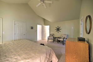 A bedroom with a bed, a desk, a chair, and a ceiling fan. - Lakefront Bolton Retreat w/ Balcony + Views! (Bolton Landing)