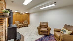 A living room with a fireplace, two armchairs, a sofa, and a patterned rug. - Burley Home w/ Playground - 1 Mi to Golf Course! (Burley)