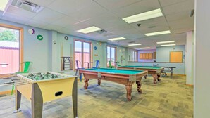 A recreational room with pool tables, foosball tables, and a ping pong table. - Fire Pit & Grill: 'woodside Nest' in Pocono Lake! (Pocono Lake)