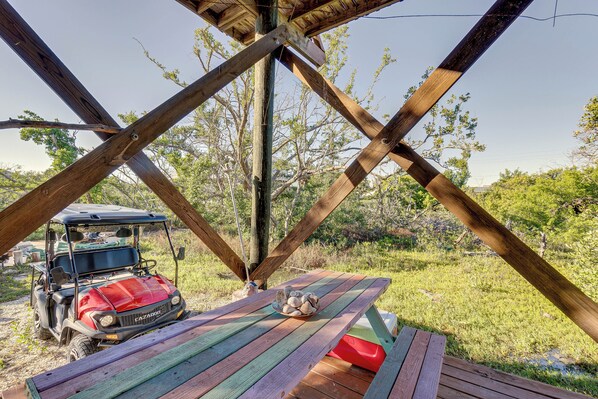 A wooden gazebo with a picnic table and a red golf cart parked underneath. - Little Gasparilla Island Paradise: Walk to Beach! (Placida)