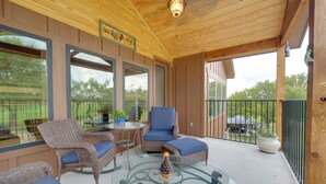 A covered outdoor area with wicker furniture, a glass table, and potted plants. - Horseshoe Bay Resort Home ~ 6 Mi to Lake Lbj! (Horseshoe Bay)