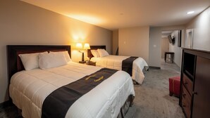 A hotel room with two beds, a desk, and a dresser. - Lock Haven Grandview Hotel (Mill Hall)