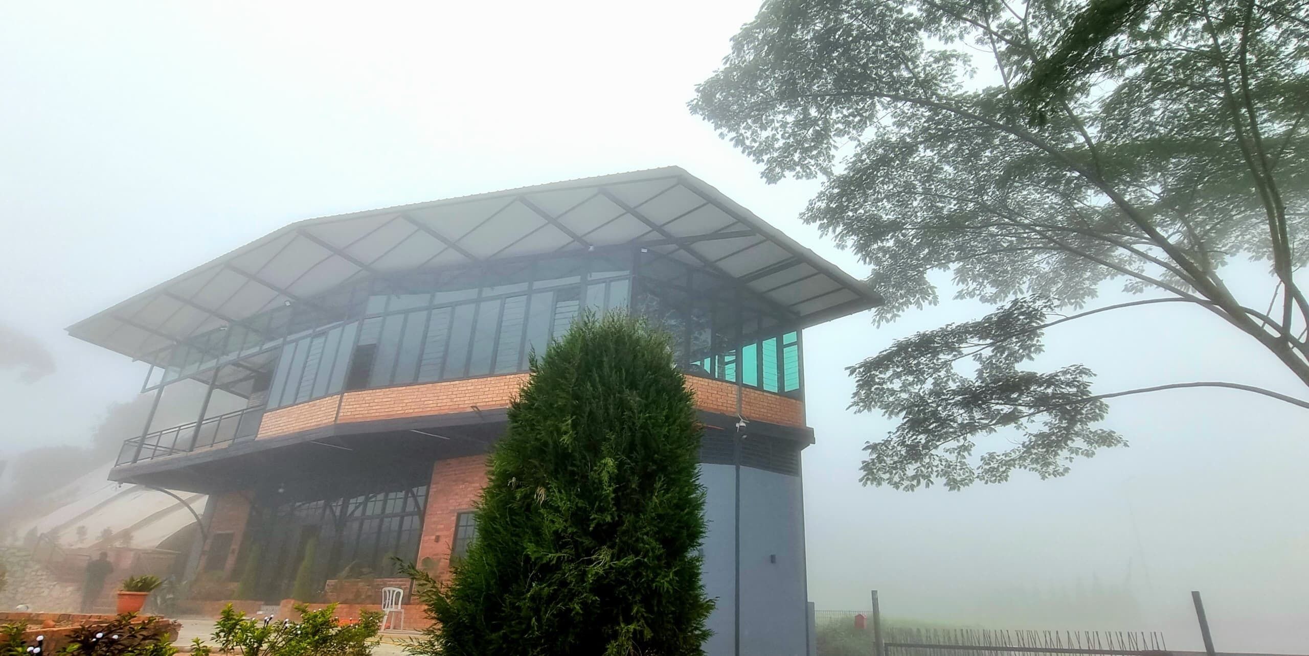 A modern building with a glass facade and a flat roof.