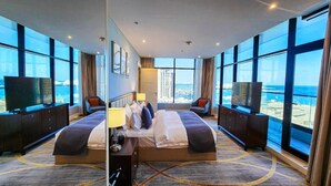 A modern hotel room with a large bed, a TV, and a city view. - Sherao Hotel Doha - Next to National Museum of Qatar & Metro (Doha)