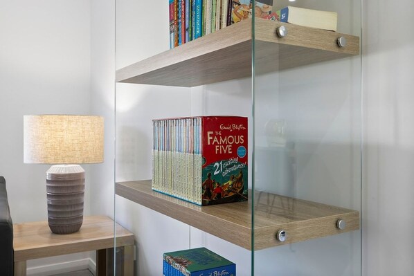 A bookshelf with a collection of books and a box labeled 'The Famous Five.'