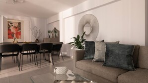 Un salon moderne comprenant un canapé, une table basse, un coin repas avec des chaises et un grand tableau abstrait.