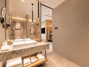A modern bathroom with a large mirror, two sinks, and a shower. - Radisson Hotel, Beijing Daxing Airport     (Daxing)