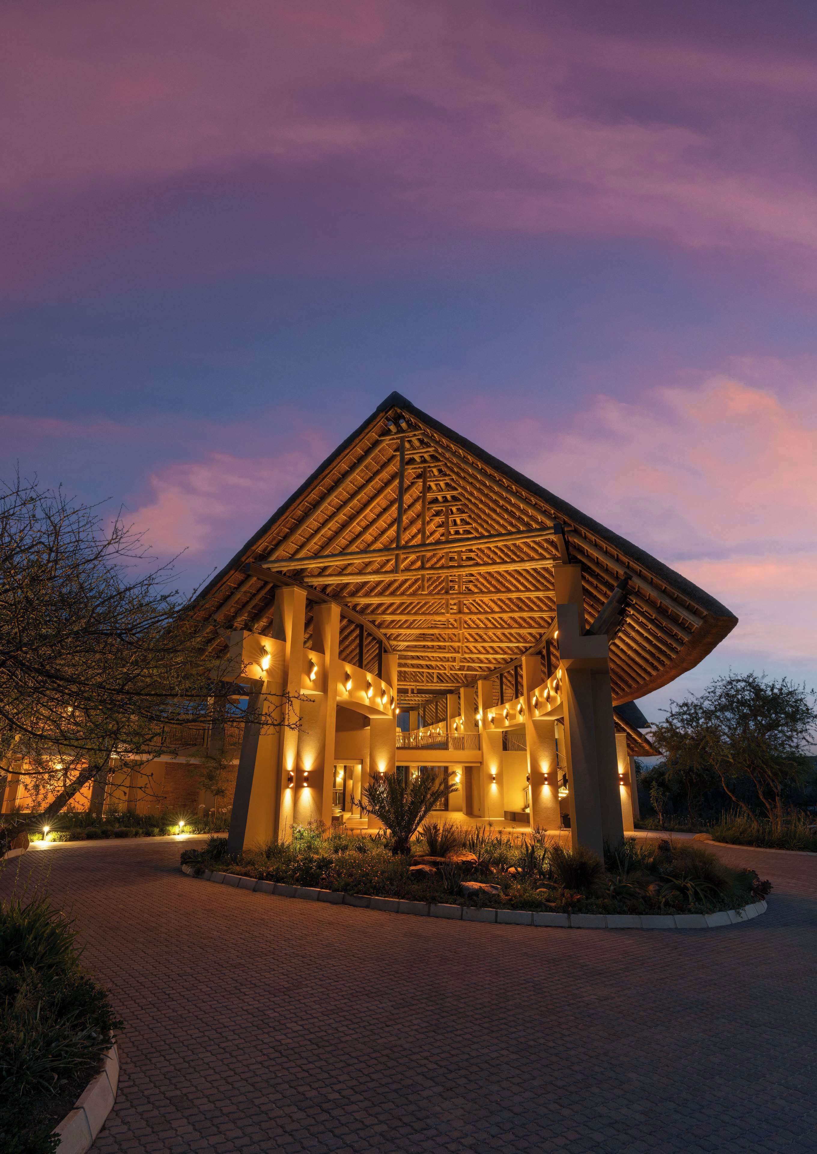 A building with a wooden roof structure and multiple light fixtures.