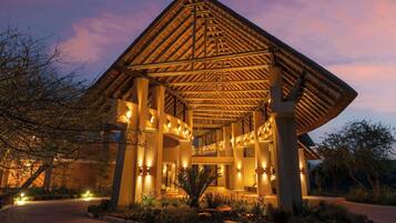 A building with a wooden roof structure and multiple light fixtures.