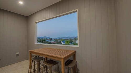Stratton Summit 4 features a living area with large windows and a balcony that let in the light.