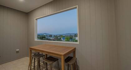 Stratton Summit 4 features a living area with large windows and a balcony that let in the light.