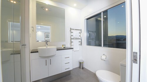 Stratton Summit 4 features a living area with large windows and a balcony that let in the light.