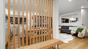A modern living room with a sofa, a wooden bench, and a cowhide rug.