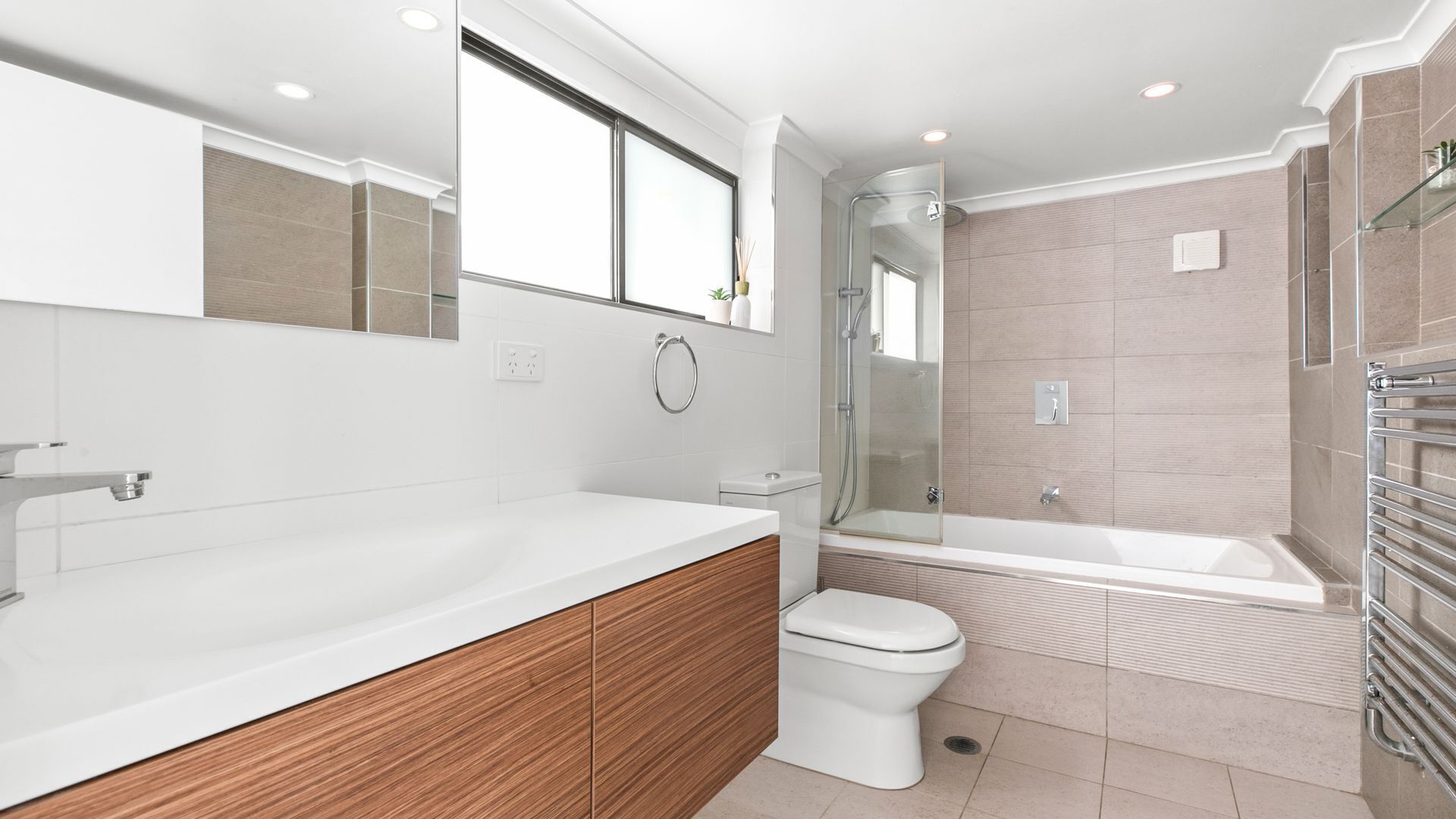 A modern bathroom with a large bathtub, a separate shower area, and a toilet.