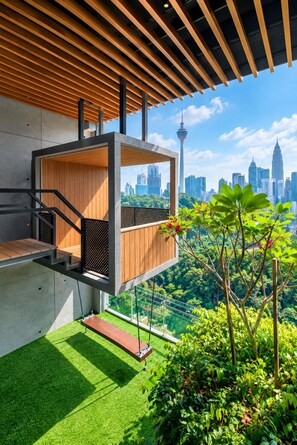 A modern outdoor balcony with a view of a city skyline, including a tower and skyscrapers. - Ceylonz Suites by Roomy (Kuala Lumpur)