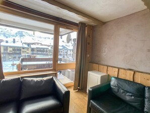Enjoy breathtaking mountain views from the large window, relax on the comfortable sofa, and stay warm with the in-room heating facilities.