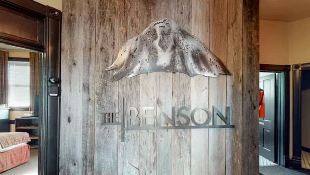 A wooden wall with a mounted animal head and the text "THE BENSON". - Benson Lodge Room -2 (Silverton)