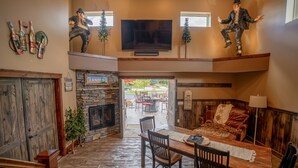 A spacious living area with a fireplace, a dining table, and a cozy seating area. - Great outdoor entertainment with slip on Cross Lake (Crosslake)