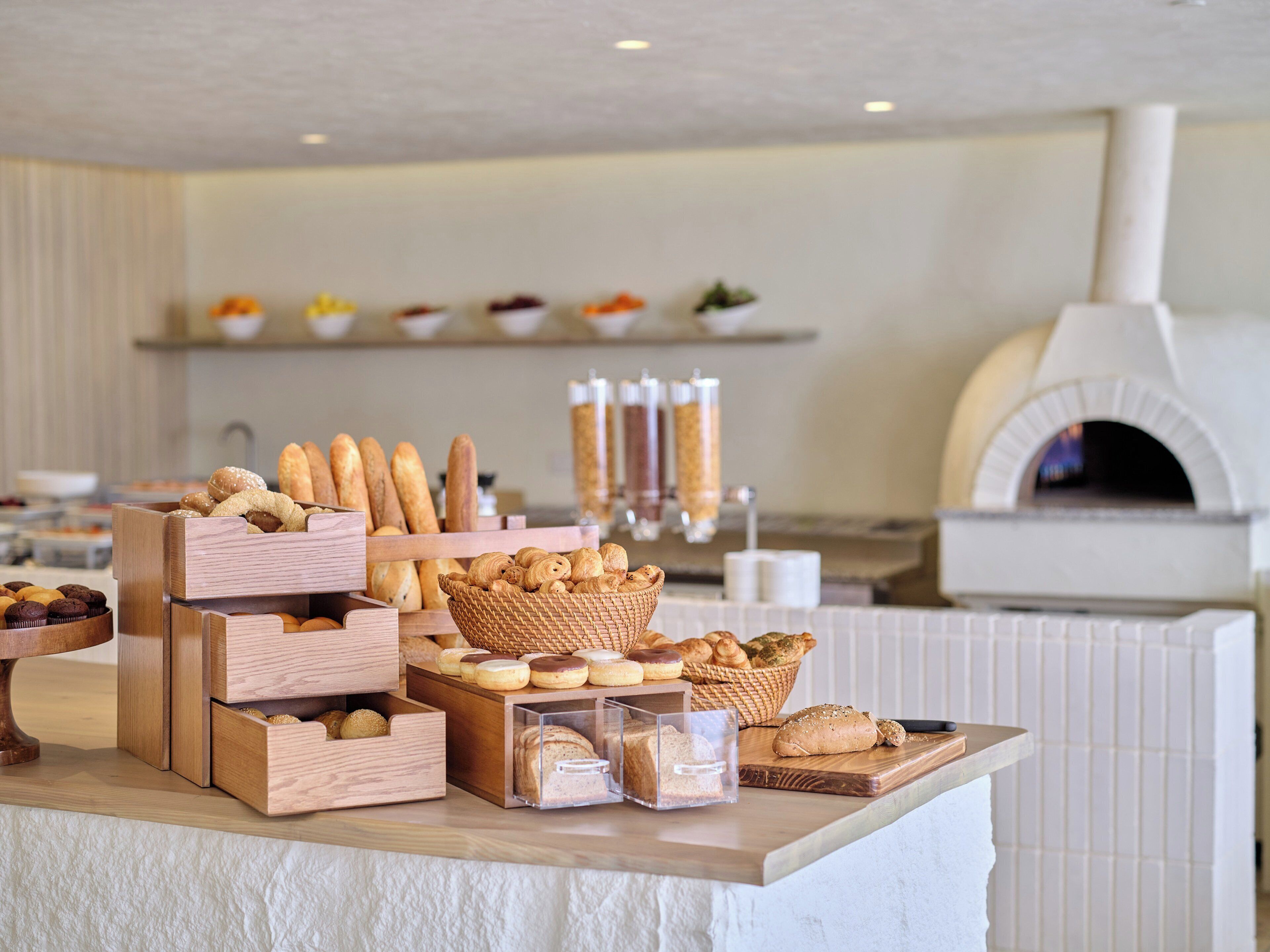 A bakery display with various breads and pastries.