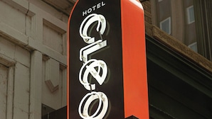 A hotel sign with the name "HOTEL OLE" in bold, illuminated letters.
