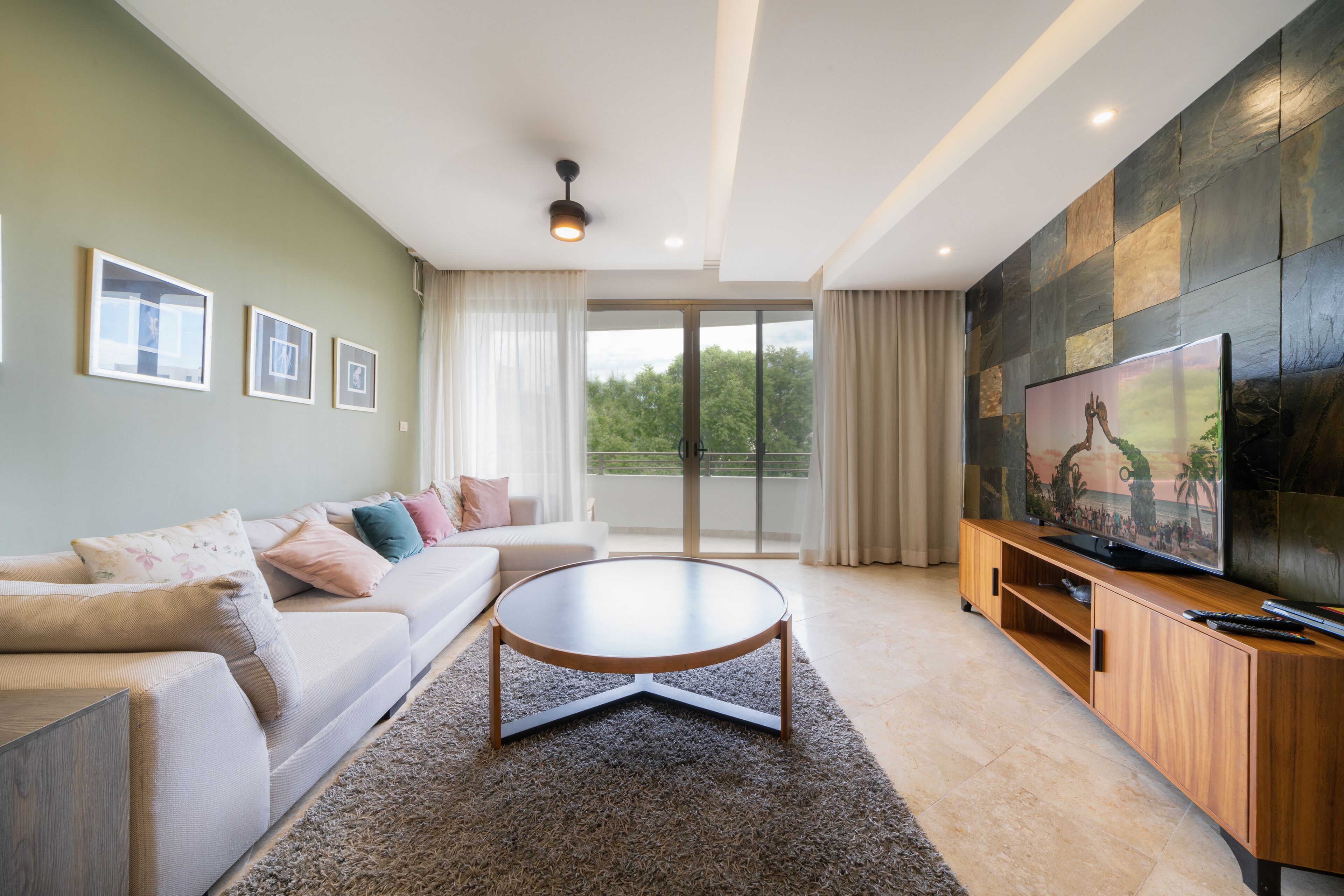 A modern living room with a sofa, coffee table, and TV.