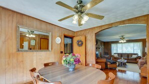 A dining area with a wooden table and chairs, a vase of flowers, and a ceiling fan. - Haysi Nature Getaway w/ Fire Pit & On-Site Creek! (Haysi)