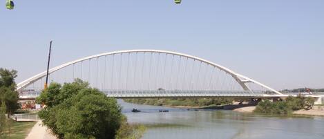 A large bridge with a pedestrian walkway and a cable car system.