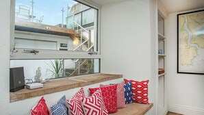 A window seat with a view of a building and a map on the wall. - 5 bedroom accommodation in Stoke Gabriel, near Totnes (Stoke Gabriel, near Totnes)