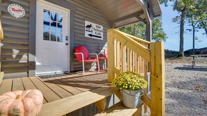 A wooden porch with a sign for 'Old School Cafe' and a red chair. - Quiet Caledonia Cabin: 18 Mi to Council Bluff Lake (Caledonia)