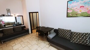 A compact living space with two black sofas, a small table, and a mirror. -  Studio. 5 Lesi Urainky blvd. Near Parus, Gulliver  (Passau)