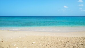 A beach with clear turquoise water and a sandy shore. - Incredible villa, beach club access- Whitehaven  (2 bed) (Westmoreland)