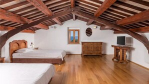 A bedroom with a wooden ceiling, a bed, a dresser, and a desk with a computer. - Amazing home in Labin - Rabac (Labin - Rabac)