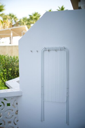A white exterior wall with a metal vent and a small window. - Holiday Apartment 'En Playa De Las Americas' with Shared Pool, Private Terrace and Wi-Fi (Playa de Las Americas)