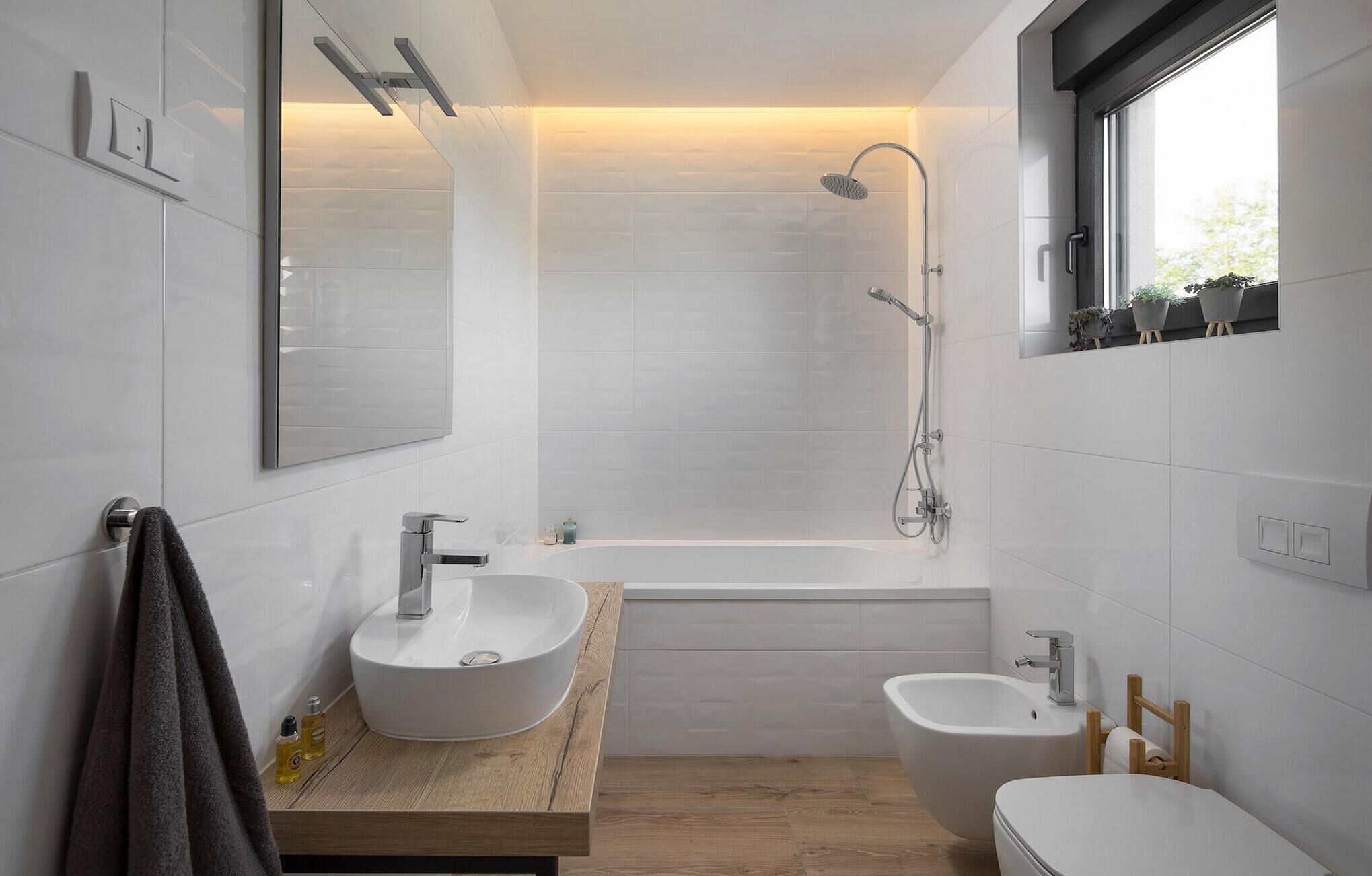 A modern bathroom with a freestanding bathtub, a sink, and a bidet.