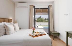 A hotel room with a bed, a breakfast tray, a window with curtains, and a view of greenery outside. - Stunning home in Rovinj (Rovinj)