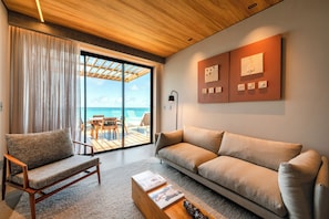 A modern living room with a sofa, armchair, and a coffee table. - Ritz Barra de São Miguel (Barra de São Miguel)