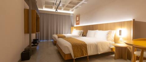 A modern hotel room with a large bed, bedside tables, a desk, and a chair.