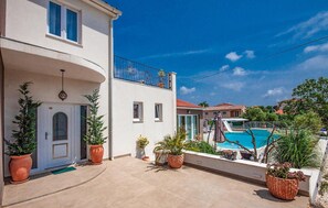 Enjoy a relaxing stay in this two-story residence with a balcony and patio area featuring a pool and slide.