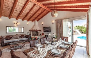 Relax in style with a comfortable sofa and fireplace, perfect for a formal dining experience.