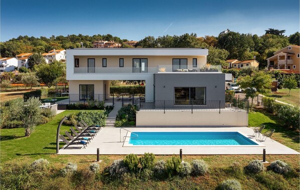 Enjoy a scenic hillside view from the multiple balconies and large windows of this villa.