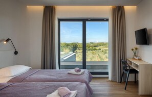 Enjoy a comfortable stay in this stylish room with two beds, a desk, and a flat-screen TV.