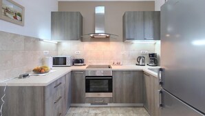 A compact kitchen with a built-in oven, microwave, and coffee maker. - Awesome home in Barban (Barban)