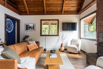 Living room area with wood burning fireplace. Photo: Shelter Upstate